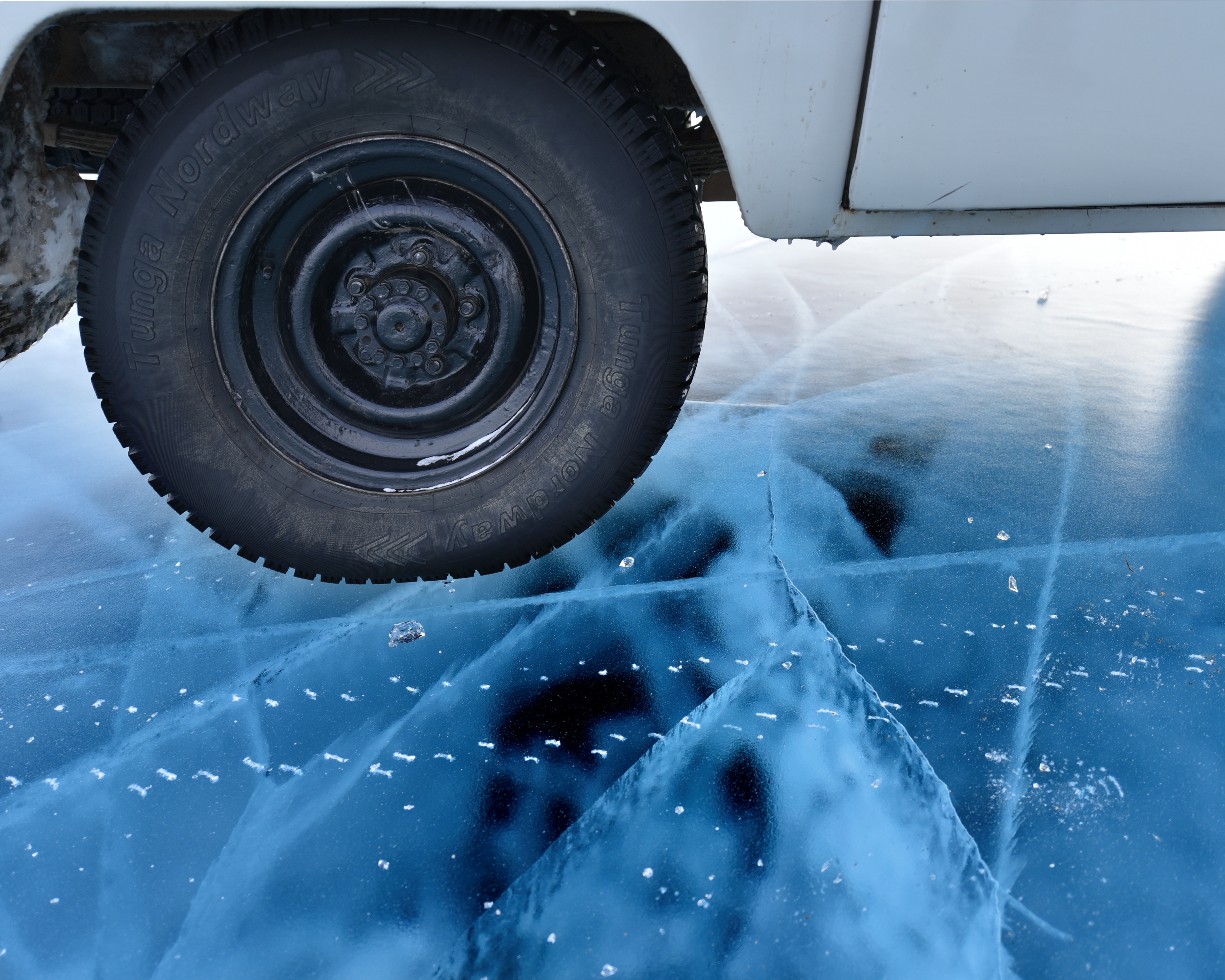 Car tire on cracked ice